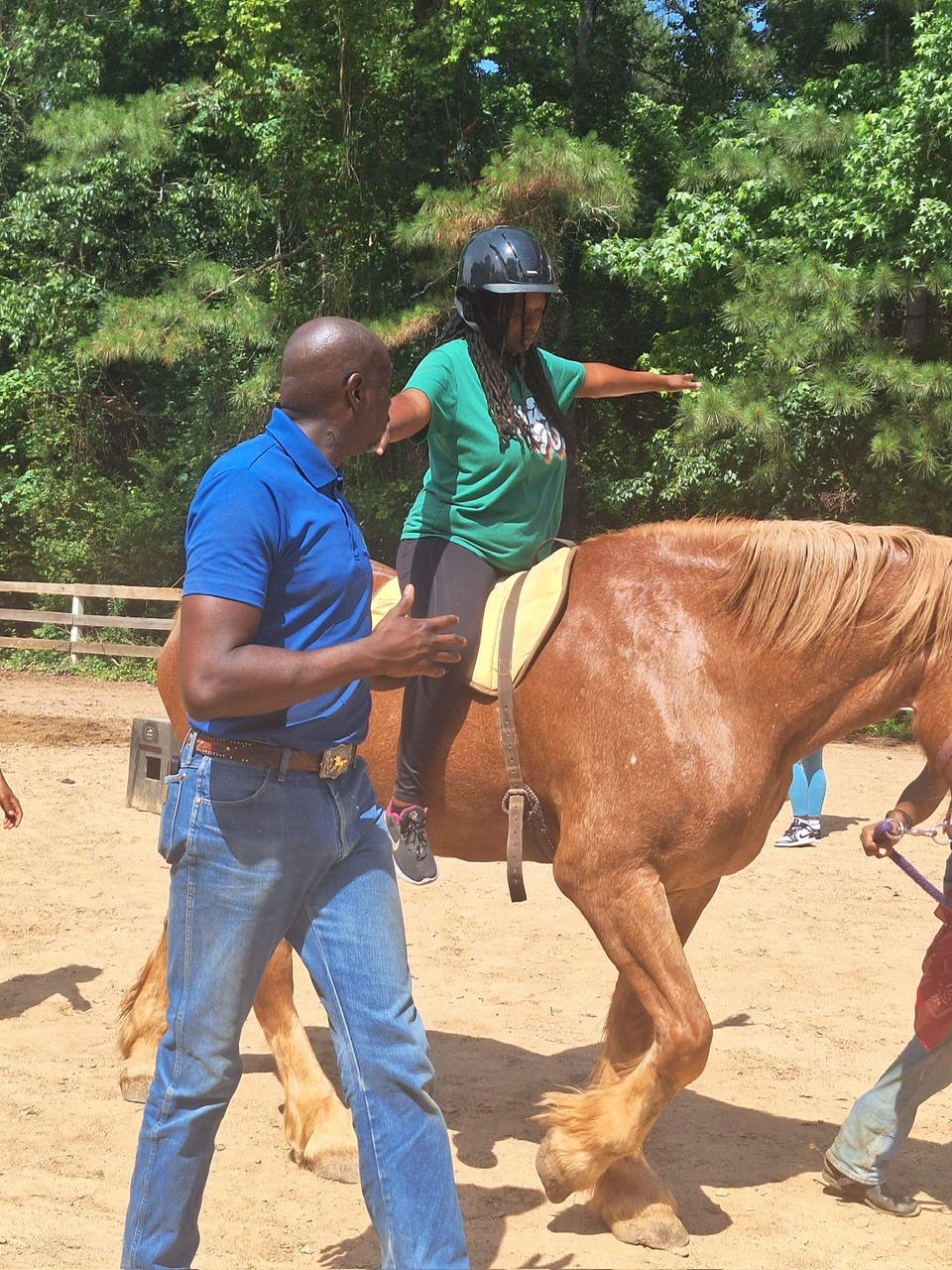 Daryl Fletcher leading a young rider and horse through an equine assisted session at SOOFA Ranch